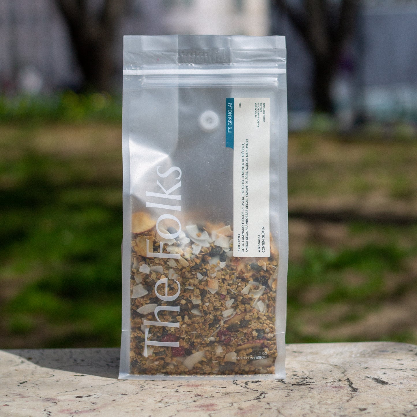 A 1kg package of The Folks Granola, showing a clear view of the crunchy, mixed-grain granola in a resealable bag.